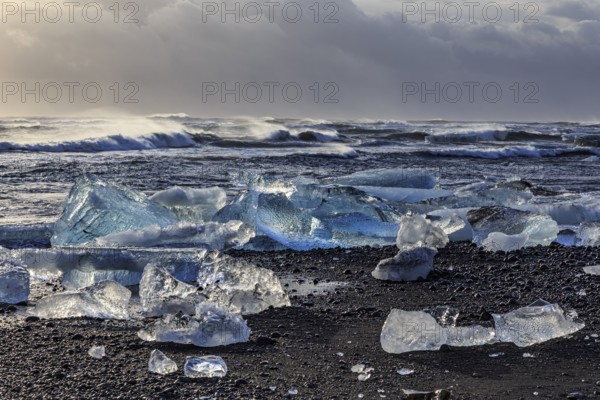 Ice floes on the beach, waves, sea, clouds, sunlight, winter, Diamond Beach, Breidamerkursandur, Jökulsarlon, Iceland, Europe