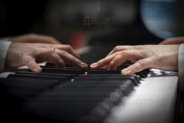 Hands of a young pianist playing on the keyboard of a Steinway & Sons grand piano, Stuttgart, Baden-Württemberg