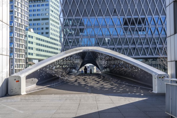 The Parkbruk, cycle and pedestrian bridge in the city centre of Antwerp, crosses a multi-lane city centre road, with tram lines, and thus connects two lively city districts Kop Spoor Noord and Eilandje, light effects by the sun, on the roadway, Belgium, Europe