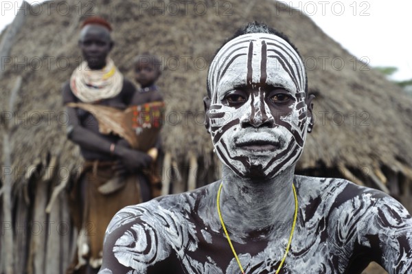 Portrait of a husband and wife and child from the Karo tribe, Omo valley, Ethiopia, Africa