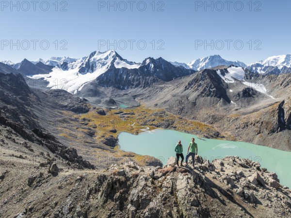 Hiker at the pass at 4000m, aerial view, mountains with glacier, mountain pass and mountain lake Ala-Kul Lake, Tien Shan, Kyrgyzstan, Asia