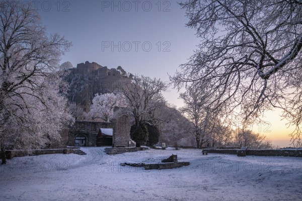 The snow-covered Karlsbastion of the Hohentwiel fortress ruins in front of sunrise on a cold winter morning, Singen am Hohentwiel, Constance district, Baden-Württemberg, Germany, Europe