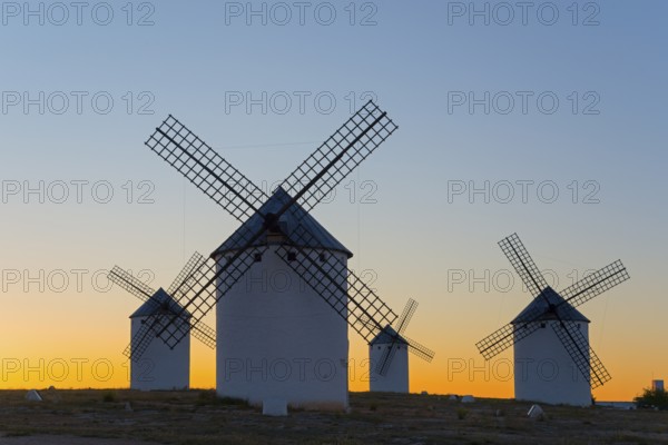 Windmills silhouetted against a soft evening sky, Campo de Criptana, Ciudad Real province, Castilla-La Mancha, Don Quixote Route, Spain, Europe