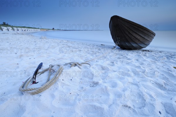 Small wooden boat anchored on the beach of the Baltic Sea, Weststrand Darß, long exposure after sunset, Wustrow, peninsula Fischland-Darß-Zingst, Mecklenburg-Vorpommern, Germany, Europe