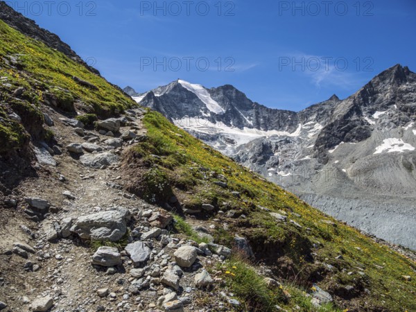 Hiking path up to mountain hut Cabane de Moiry, Moiry glacier in the back, Valais, Switzerland, Europe