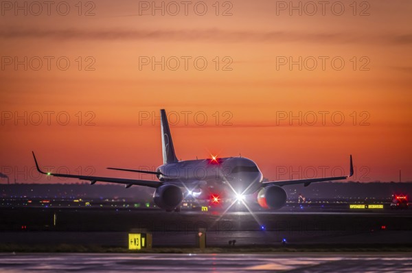Early in the morning in front of sunrise at the airport, a Lufthansa aircraft stands ready for take-off on the runway, Fraport, Frankfurt am Main, Hesse, Germany, Europe