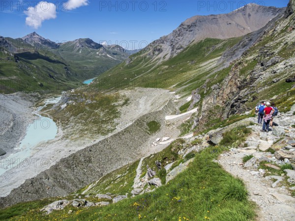 Hiking trail up to mountain hut Cabane de Moiry, glacial moraine, lake Lac de Moiry in the back, Valais, Switzerland, Europe