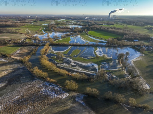 Selm, North Rhine-Westphalia, Germany, flood on the Lippe, river in the Ruhr area, the fields, the farmers' agricultural land next to the watercourse are flooded, serve as retention areas, flood areas for flood protection. In the background the Trianel coal-fired power station in Lünen, Europe