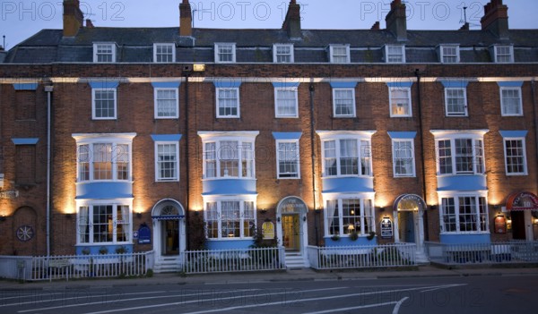 Row of guest houses and small hotels at night on the Esplanade, Weymouth, Dorset, England, United Kingdom, Europe