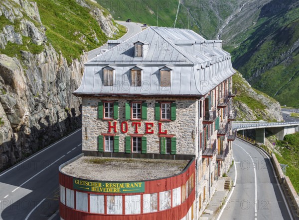 Hotel Belvédère on the Furka, the most famous pass hotel in the world. The building is closed and falling into disrepair. A lost place. Rhone glacier. Drone photo. Obergoms, Canton Valais, Switzerland, Europe