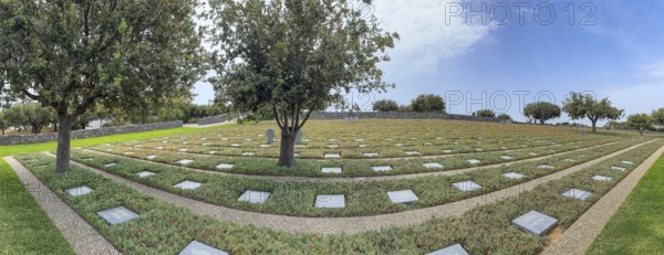Panoramic photo wide view over part of German military cemetery inaugurated in 1974 by Volksbund Deutsche Kriegsgräberfürsorge on former battlefield in World War II heavily contested hill Height 107, Maleme, Crete, Greece, Europe