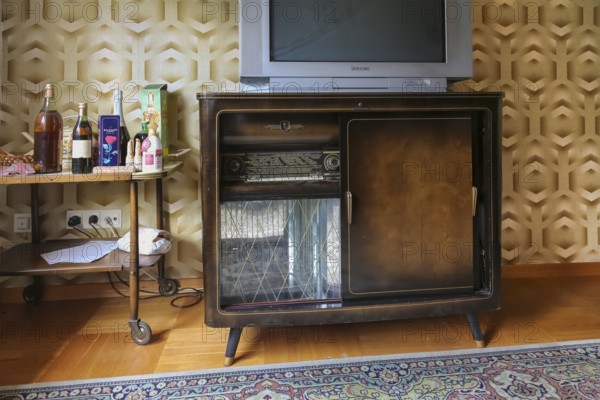 Lost Places, abandoned house, vacant building, old-fashioned furniture, good parlour, living room 1950s style, living in the economic miracle, furniture of the 50s, old radio, radio cabinet, liquor bottles, district Honau, Lichtenstein, Baden-Württemberg, Germany, Europe