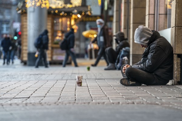 First day of the Christmas lockdown in the Corona crisis, homeless people at Neumarkt, closed shops, hardly any passers-by, in Cologne, North Rhine-Westphalia, Germany, Europe