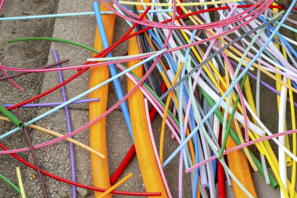 Cable remnants from empty conduits for fibre optic cables that have been laid, in which the actual fibre optic cable is later blown in and connected to the respective house connection. Essen, North Rhine-Westphalia, Germany, Europe