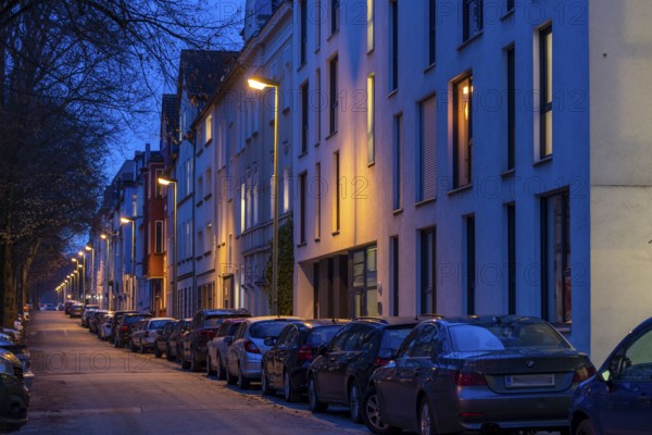 Residential street, many apartment buildings in a residential neighbourhood, evening, lantern lighting, Essen, North Rhine-Westphalia, Germany, Europe