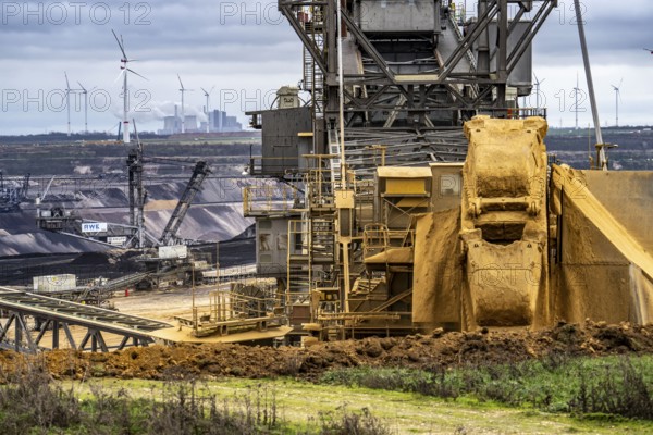 Opencast lignite mine Garzweiler 2, bucket wheel excavator 261 excavating the surface, at the rest of the hamlet of Lützerath, behind excavator 288, mining lignite, Neurath lignite-fired power station, wind farm, Erkelenz, North Rhine-Westphalia, Germany, Europe