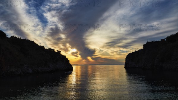 Sunrise with a view through a bay between cliffs and clouds, Mani Peninsula, Peloponnese, Greece, Europe