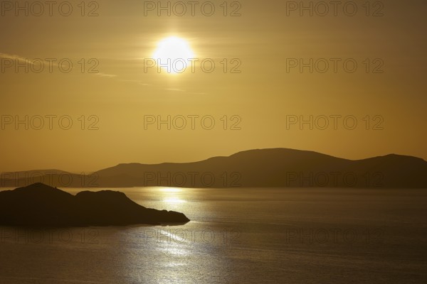 Silent sunset over the sea, golden reflection and silhouetted islands, Makri Island, Alimia Island, Kritinia Castle, St John's Castle, Kritinia, Rhodes, Dodecanese, Greek Islands, Greece, Europe