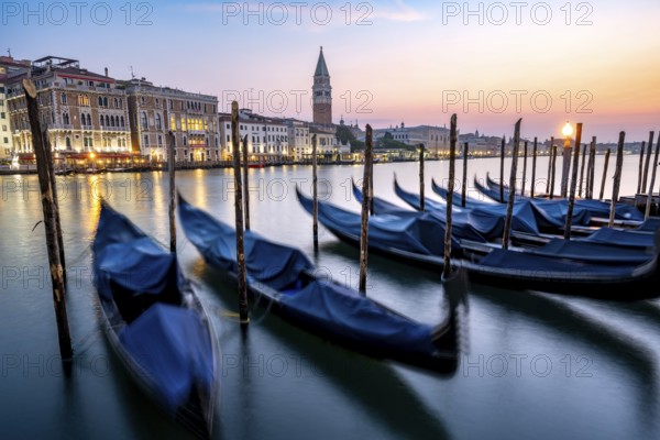 Venetian gondolas, boat dock at the customs office on the Grand Canal, Gondola Traghetto Dogana, Campanile behind, long exposure at sunrise, Venice, Veneto, Italy, Europe