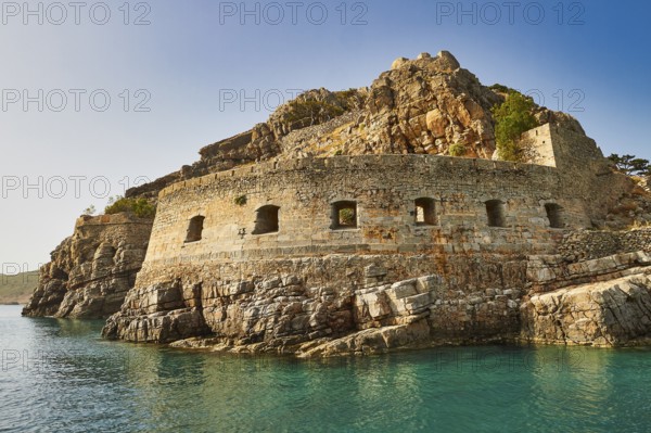 Historic rock fortress on the edge of the sea under a clear blue sky, Venetian sea fortress, Leper Island, Spinalonga, Elounda Bay, Mirabello Bay, East Crete, Crete, Greek Islands, Greece, Europe