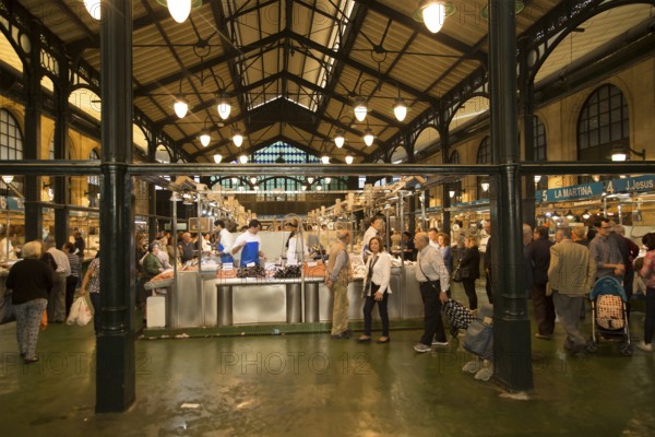 People shopping at fishmonger stalls inside historic covered market building, Jerez de la Frontera, Spain, Europe