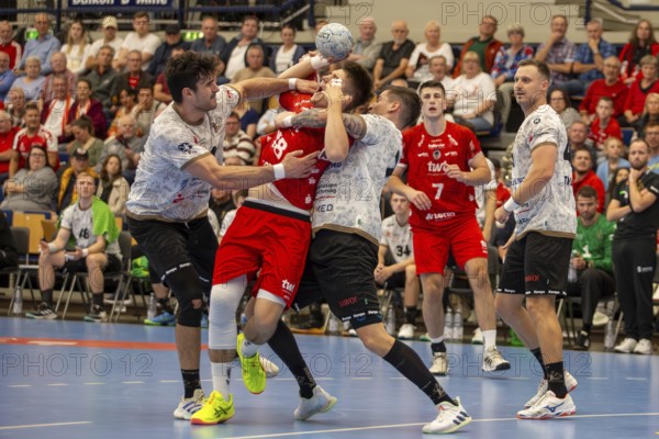 11.09.2024, 2nd HBL (German Handball League), Matchday 7 (early game) : Owls Ludwigshafen against HC Elbflorenz 2006. picture: Magnus Grupe (18, Ludwigshafen) is put through the wringer by Doruk Pehlivan and Ediz Aktas (11, 21, Elbflorenz)