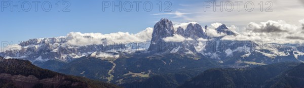 Snow-covered mountains of the Sella Group Mountain landscape under blue sky and clouds, a wide natural landscape in panoramic view, South Tyrol, Italy, Europe