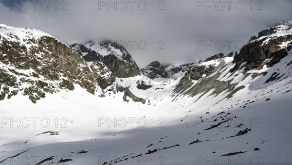 High mountain valley with mountain peak Piz Calderas in winter, view at the Chamanna Jenatsch in winter, Grisons Haute Route, Albula Alps, Rhaetian Alps, Grisons, Eastern Switzerland, Switzerland, Europe