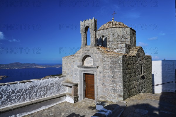 Historic chapel on a hill overlooking the sea under a clear sky, Agiou Theologou Monastery, St John's Monastery, Chora, Patmos, Dodecanese, Greek Islands, Greece, Europe
