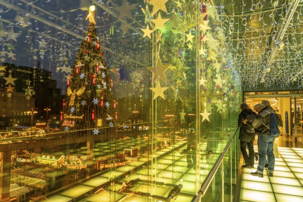 Christmas market in Dortmund, Hansaplatz, view from a pedestrian gallery between 2 department stores, onto the market with the biggest Christmas tree in the world, North Rhine-Westphalia, Germany, Europe