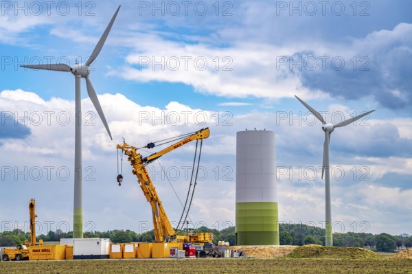 Wind turbine repowering, in the Issum-Oermten wind farm, 9 wind turbines in operation for over 20 years (Enercon model series E-58) in the background are being replaced by 4 new turbines (type Enercon E-160), which will then generate 4 times more electricity than the old 9 wind turbines, North Rhine-Westphalia, Germany, Europe