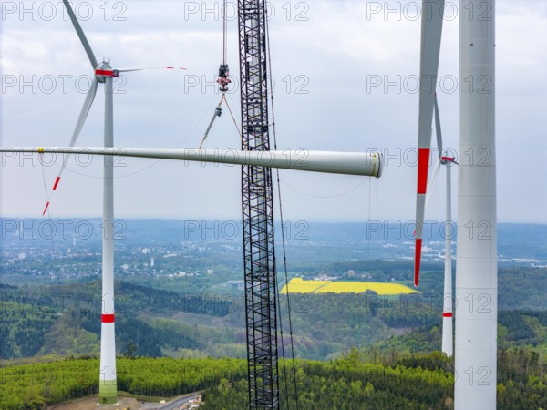 Erection of a wind turbine, wind energy plant, assembly of the third blade, with a crawler lattice crane, wind farm near Hagen, North Rhine-Westphalia, Germany, Europe