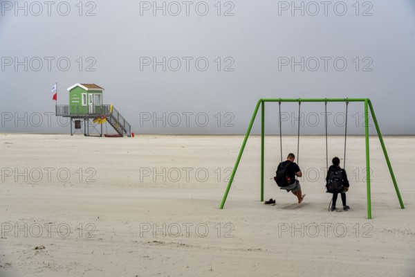 North Sea island of Langeoog, early summer, shortly after the first easing of the lockdown in the Corona crisis, foggy weather, still quite few tourists on the beach, DLRG watchtower, Lower Saxony, Germany, Europe