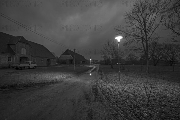 Unpaved village street in the evening, Othenstorf. Mecklenburg-Western Pomerania, Germany, Europe