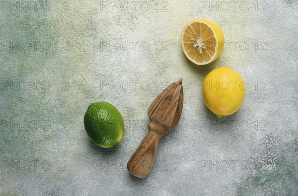Wooden citrus reamer, manual lemon juicer, made of acacia wood, with citrus fruits on the table, top view