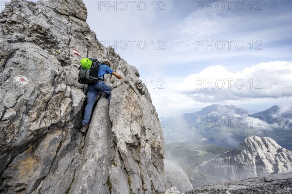 Mountaineer climbing on the rock, on a narrow rocky ridge, Watzmann crossing to the Watzmann Mittelspitze, Berchtesgaden National Park, Berchtesgaden Alps, Bavaria, Germany, Europe