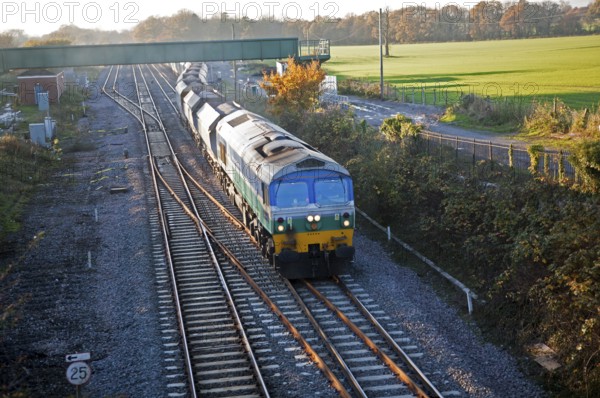 Diesel locomotive freight train on the West Coast mainline at Woodborough, Wiltshire, England, UK