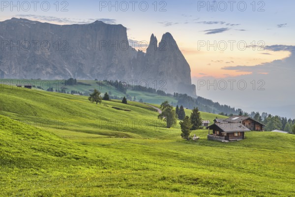 Alpine huts in front of Schlern at sunset, Seiser Alm, Dolomites, South Tyrol, Italy, Europe