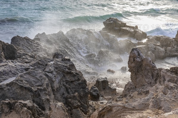 Sea water lashes over the eroded rocks on Salines beach, Ibiza, Balearic Islands, Mediterranean Sea, Spain, Europe