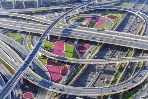 Intersection of Sheikh Zayed Road traffic on the road near the Burj Khalifa with Metro in Dubai, United Arab Emirates, Asia