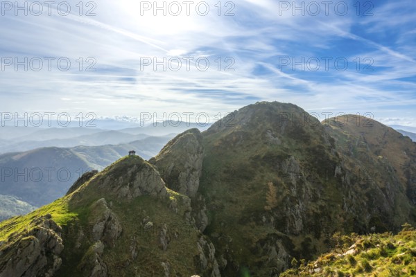 Hikers enjoy the stunning panoramic view from the summit of aiako harria, also known as penas de aia, in oiartzun, gipuzkoa