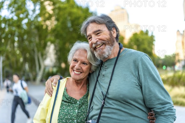 Close-up of smiling caucasian senior couple embracing visiting a city on holidays