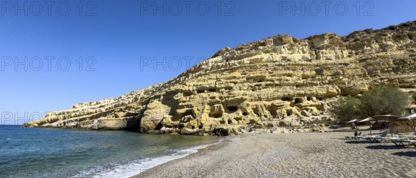 View of sandstone rocks Partial view of former Roman necropolis with sandstone caves carved into sandstone Cave tombs Grottoes in rocks on the north side of Matala Bay, in the 60s and 70s hippie caves Caves for dropouts and hippies today excursion destination on the south coast of the island of Crete, left at the edge of the picture Libyan Sea Mediterranean, Matala, Crete, Greece, Europe