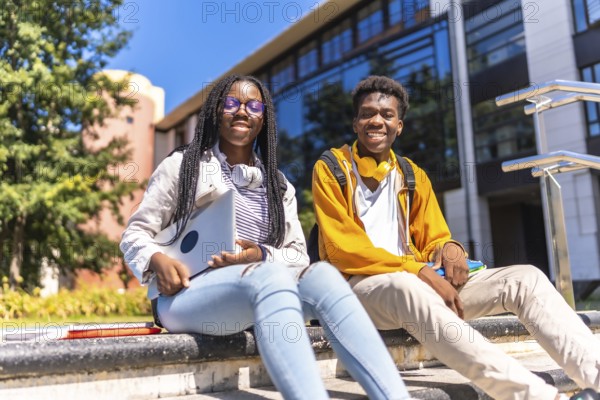 Low angle view portrait of two cool african american students in the university campus