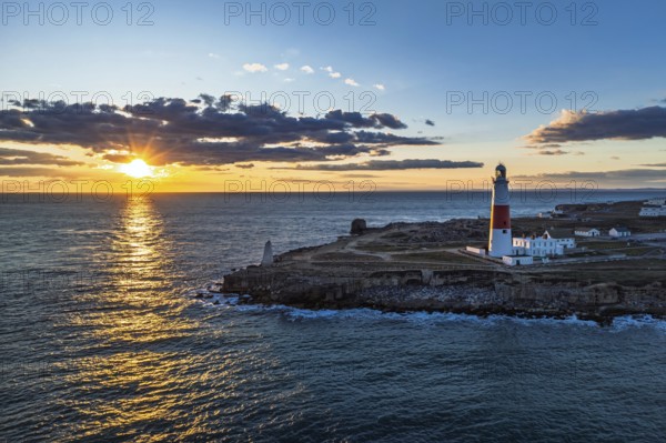 Sunset over Portland Bill Lighthouse from a drone, Portland Bill, Isle of Portland, Dorset, England, United Kingdom, Europe