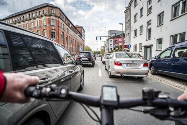 Cycling in the city, city centre road, no cycle lane, two-lane traffic in both directions, cyclists' perspective, Essen, North Rhine-Westphalia, Germany, Europe