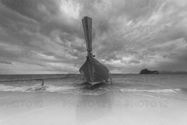 Longtail boat on the beach, dark rain clouds behind, Koh Ngai Island, Andaman Sea, Satun Province, Southern Thailand, Thailand, Asia