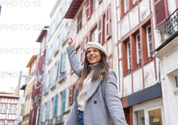 Young beauty stylish woman with warm clothes and beret enjoying in the city