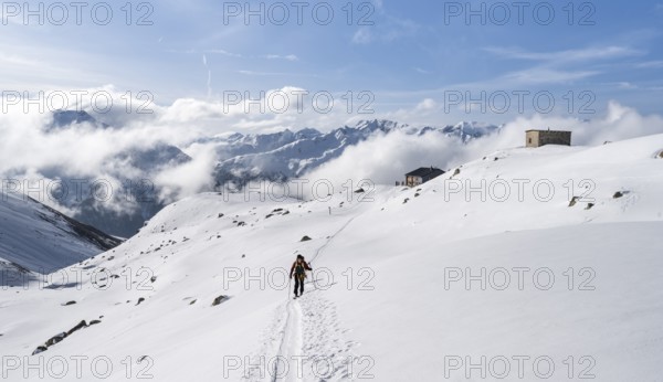 Ski tourers in a wintry mountain landscape, Bündner Haute Route ski tour, Albula Alps, Rhaetian Alps, Grisons, Eastern Switzerland, Switzerland, Europe