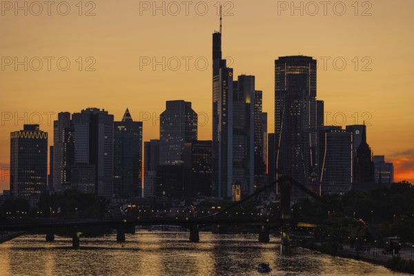 The lights of Frankfurt's banking skyline begin to glow in the evening after sunset, Frankfurt am Main, Hesse, Germany, Europe